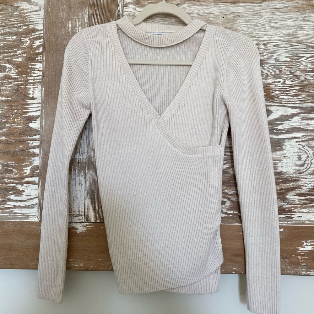 Cream sweater with cut out v-neck